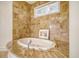 Luxurious bathroom features a marble countertop and a large soaking tub at 5084 Timber Race Crse, Hollywood, SC 29449