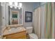 Bathroom with vanity, mirror, and shower with colorful curtain, with a view into the bedroom at 5084 Timber Race Crse, Hollywood, SC 29449