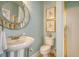 Charming bathroom features a pedestal sink, decorative mirror, and shower with gold trim at 5084 Timber Race Crse, Hollywood, SC 29449