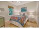 Cozy bedroom with colorful quilt, light wood floors, and window at 5084 Timber Race Crse, Hollywood, SC 29449