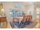 Bright dining room with large windows, elegant furniture, and access to outdoor space at 5084 Timber Race Crse, Hollywood, SC 29449
