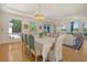 Bright dining room features hardwood floors, large windows, and stylish chandelier at 5084 Timber Race Crse, Hollywood, SC 29449