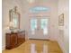 Elegant foyer features gleaming hardwood floors, a decorative mirror, and stylish chandelier at 5084 Timber Race Crse, Hollywood, SC 29449