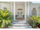 Grand front entrance with stately columns, beautiful double doors, and manicured landscaping at 5084 Timber Race Crse, Hollywood, SC 29449
