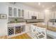 Stylish kitchen features white cabinetry, granite countertops, a wine fridge and breakfast bar at 5084 Timber Race Crse, Hollywood, SC 29449