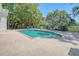 Backyard pool area with lounge chairs and outdoor dining set and lush green landscape at 5084 Timber Race Crse, Hollywood, SC 29449