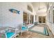 Relaxing screened porch features tile flooring, ceiling fan, and comfortable wicker seating at 5084 Timber Race Crse, Hollywood, SC 29449