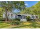 Expansive, single-story home with lush landscaping and a screened-in porch, perfect for outdoor relaxation at 5084 Timber Race Crse, Hollywood, SC 29449