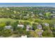 Aerial view of a neighborhood with lush landscaping, a golf course, and the ocean in the background at 55 Seagrass Ln, Isle of Palms, SC 29451