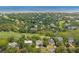 Overhead view capturing a luxurious neighborhood's golf course and lush landscaping near the ocean at 55 Seagrass Ln, Isle of Palms, SC 29451