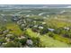 Stunning aerial view of waterfront homes, a golf course, and winding waterways of a coastal community at 55 Seagrass Ln, Isle of Palms, SC 29451