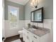 Bathroom with granite vanity, grey walls, white wainscoting and dark hardwood flooring at 55 Seagrass Ln, Isle of Palms, SC 29451