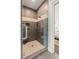 Modern tiled shower featuring a built-in seat, multiple showerheads, and a glass door at 55 Seagrass Ln, Isle of Palms, SC 29451
