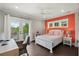 Bright bedroom with wood floors, access to a balcony, and an accent wall at 55 Seagrass Ln, Isle of Palms, SC 29451