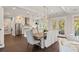 Elegant dining area with a modern chandelier, stylish chairs, and views of the outdoor scenery at 55 Seagrass Ln, Isle of Palms, SC 29451