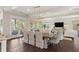 Elegant dining room with a modern chandelier, dark hardwood floors, and French doors to the outdoors at 55 Seagrass Ln, Isle of Palms, SC 29451
