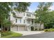 Beautiful multi-story home with a three-car garage and lush landscaping enhancing its curb appeal at 55 Seagrass Ln, Isle of Palms, SC 29451