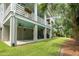 Rear of house featuring a covered patio and lawn at 55 Seagrass Ln, Isle of Palms, SC 29451