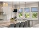 Well-lit kitchen with a large island, pendant lighting, marble countertops, and stainless steel appliances at 55 Seagrass Ln, Isle of Palms, SC 29451