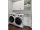 The functional laundry room is complete with a sink, granite countertop, and modern washer and dryer at 55 Seagrass Ln, Isle of Palms, SC 29451