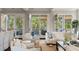 Bright living room featuring comfortable furniture, neutral tones, and access to an outdoor balcony at 55 Seagrass Ln, Isle of Palms, SC 29451