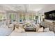 Comfortable living room with white sofas, ceiling fan, and french doors leading to the outside porch at 55 Seagrass Ln, Isle of Palms, SC 29451