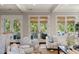 Comfortable living room featuring stylish furniture, neutral tones, and access to the outdoor balcony at 55 Seagrass Ln, Isle of Palms, SC 29451