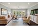 Stylish living room showcasing large windows, comfortable seating, and a ceiling fan at 55 Seagrass Ln, Isle of Palms, SC 29451