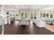 Bright open-concept living area with dining table, couch, and white furniture on dark wood flooring at 55 Seagrass Ln, Isle of Palms, SC 29451