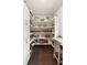 Bright pantry with built-in shelving, a work counter, ample storage, and hardwood floors at 55 Seagrass Ln, Isle of Palms, SC 29451