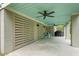 Covered patio featuring a concrete floor, ceiling fans, and grey slat wall at 55 Seagrass Ln, Isle of Palms, SC 29451