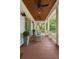 Relaxing porch with wood floors, ceiling fans, rocking chairs, and scenic views of the surrounding greenery at 55 Seagrass Ln, Isle of Palms, SC 29451