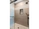 Tiled walk-in shower with mosaic details, a built-in niche, and modern fixtures at 55 Seagrass Ln, Isle of Palms, SC 29451