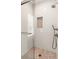 Modern shower featuring white subway tile, niche, glass door, and hexagon tile flooring at 55 Seagrass Ln, Isle of Palms, SC 29451