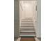 Interior staircase featuring white risers and wood treads at 55 Seagrass Ln, Isle of Palms, SC 29451
