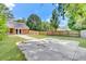 Picturesque backyard featuring a well-manicured lawn, tall trees, and a concrete area, framed by a wooden fence at 703 Temple Rd # A, Ladson, SC 29456