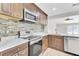 Modern kitchen featuring stainless steel appliances, stylish backsplash, and wood cabinets at 703 Temple Rd # A, Ladson, SC 29456