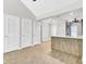 Open-concept kitchen with a breakfast bar, wooden accents, and views of the living area at 703 Temple Rd # A, Ladson, SC 29456