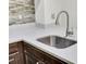 Close-up of a kitchen featuring a stainless steel sink, stone countertops, and ample lighting at 703 Temple Rd # A, Ladson, SC 29456