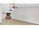 Spacious living room with wood floors, ceiling fans, and partial view of the kitchen at 703 Temple Rd # A, Ladson, SC 29456