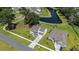 Aerial view of a beautiful home with manicured lawn, adjacent to a tranquil pond in a friendly neighborhood at 7045 Stonecrop Ln, Johns Island, SC 29455