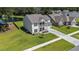 Aerial view showcasing the home's well-maintained lawn, spacious layout, and proximity to a serene pond at 7045 Stonecrop Ln, Johns Island, SC 29455