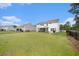 Expansive backyard with lush green grass, black fence, and screened in porch at 7045 Stonecrop Ln, Johns Island, SC 29455