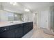 Bathroom features a double vanity, a large mirror, and a glass-enclosed shower at 7045 Stonecrop Ln, Johns Island, SC 29455