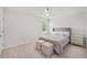 Bedroom with a bed, a ceiling fan, bedside tables, and two ottomans at 7045 Stonecrop Ln, Johns Island, SC 29455