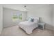 Bright bedroom with a queen-sized bed, a ceiling fan, and side tables with lamps at 7045 Stonecrop Ln, Johns Island, SC 29455