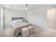 Bedroom with a bed, a ceiling fan, bedside tables, and two ottomans at 7045 Stonecrop Ln, Johns Island, SC 29455