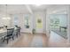 Bright dining room featuring wood floors, large windows, and a stylish dining set for entertaining guests at 7045 Stonecrop Ln, Johns Island, SC 29455