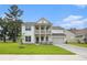 Charming two-story home with a welcoming double porch and well-manicured lawn on a sunny day at 7045 Stonecrop Ln, Johns Island, SC 29455