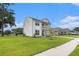 Inviting two-story home features a spacious front yard, a double porch, and a welcoming neighborhood at 7045 Stonecrop Ln, Johns Island, SC 29455